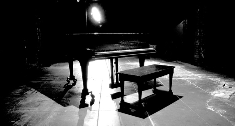 Piano on a dimly lit stage